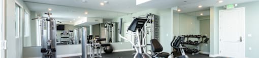 a gym with treadmills and other exercise equipment in a building