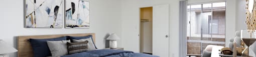 a bedroom with a bed and a desk with a chair