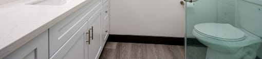 a white bathroom with a toilet and a sink