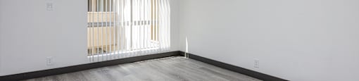an empty room with white walls and a ceiling fan