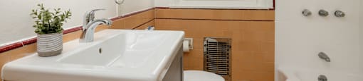 a bathroom with a sink toilet and bathtub