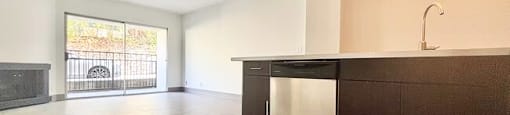 A kitchen with brown cabinets and a black countertop.