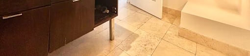 A bathroom with a sink, mirror, and wooden cabinets.
