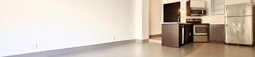 A kitchen area with a refrigerator, microwave, and oven.