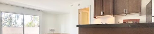 A room with a brown counter and tiled floor.