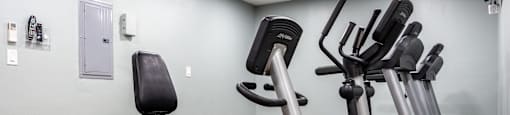 a gym with various exercise equipment on the floor and