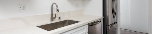 a kitchen with white cabinets and a sink