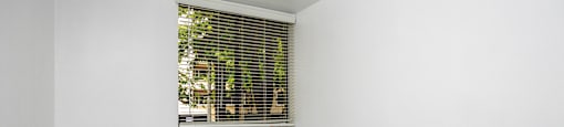an empty room with white walls and a window