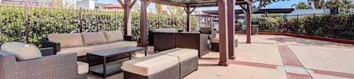 a patio with couches and a coffee table