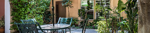 a patio with a table and chairs and an umbrella