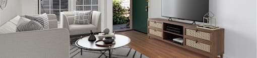 a living room with white walls and hardwood floors