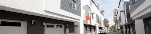 A row of modern houses with garages on the side.