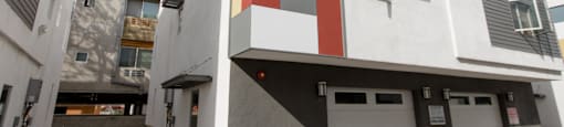 A white building with a red, green, and blue square on the side.