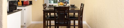 a dining room with a table and chairs and a ceiling fan