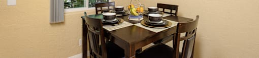 a dining room with a table and chairs and a ceiling fan