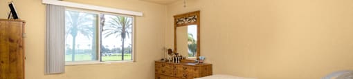 a bedroom with a bed and a ceiling fan