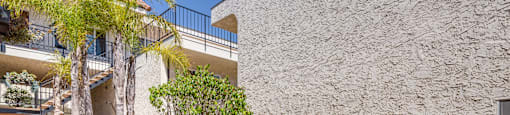 a patio with potted plants in front of a building