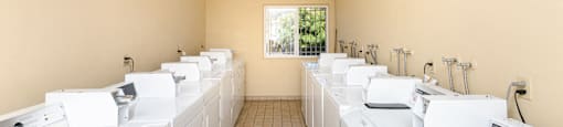 a washer and dryer room with white washing machines