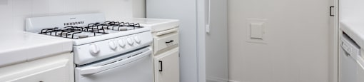 a kitchen with white appliances and white cabinets and a white refrigerator