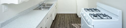 a kitchen with white appliances and white cabinets