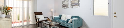 the living room of an apartment with a blue couch and a coffee table