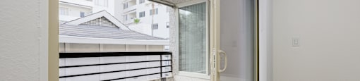 a bedroom with a balcony and a door to a balcony