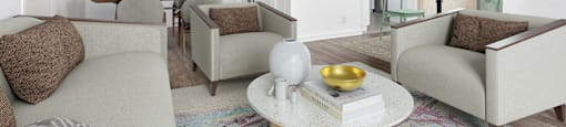 a living room with couches and chairs and a table