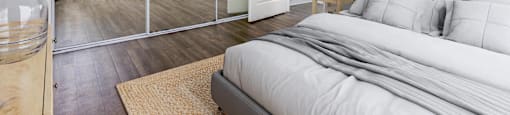 a bedroom with a large bed and a glass closet