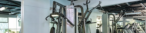 A gym with a variety of equipment including a leg press machine.