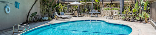 a swimming pool with a building in the background