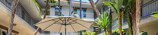 a patio with a table and chairs and an umbrella