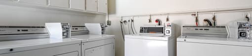 a kitchen with white appliances and white cabinets