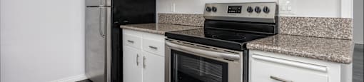 a kitchen with stainless steel appliances and white cabinets