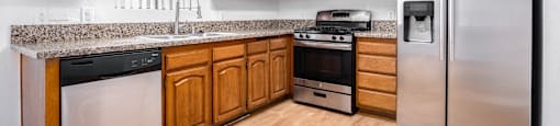 a kitchen with stainless steel appliances and wooden cabinets