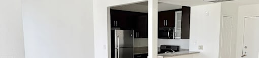 A kitchen with a refrigerator, microwave, and oven.