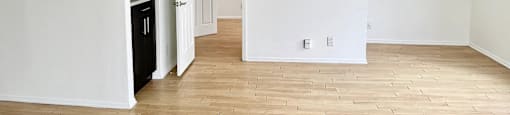 A room with a wooden floor and white walls.