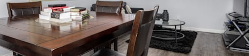 a dining room with a table and chairs and a tv in a living room