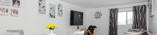 a living room with a table and chairs and a tv