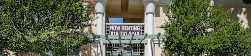 a building with a door and a sign that reads how renting