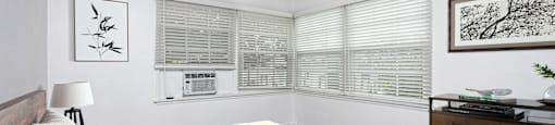 a bedroom with a large bed and a ceiling fan