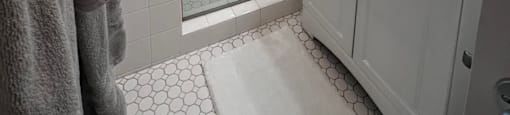 a bathroom with a shower and a sink and a mirror