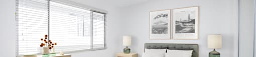 a bedroom with a bed and two windows