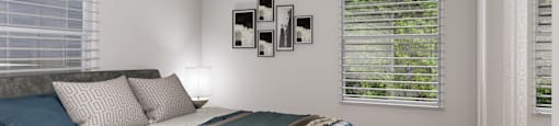a bedroom with a bed and two windows