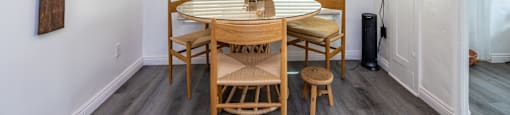a dining area with a wooden table and four chairs