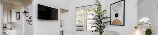 a living room with hardwood floors and white walls