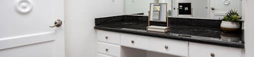 a bathroom with a vanity and a mirror