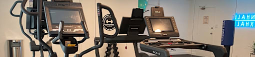 A gym with treadmills and elliptical machines.