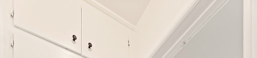 A white cabinet with two doors is open.