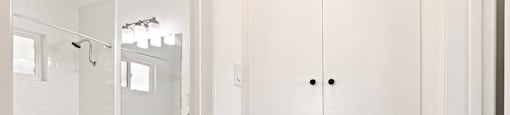 A white bathroom with a toilet, sink, and medicine cabinet.