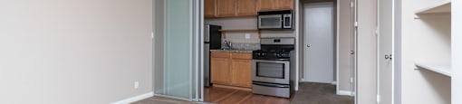 A kitchen with a white ceiling and a white door.